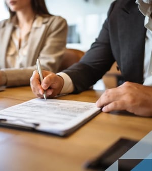 Man signing a business document