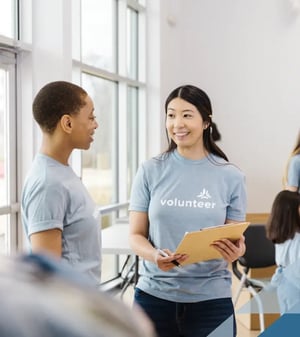 two volunteers talking at an event