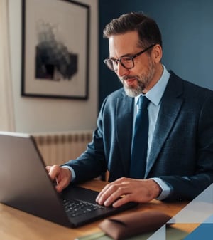 A businessman working on a laptop